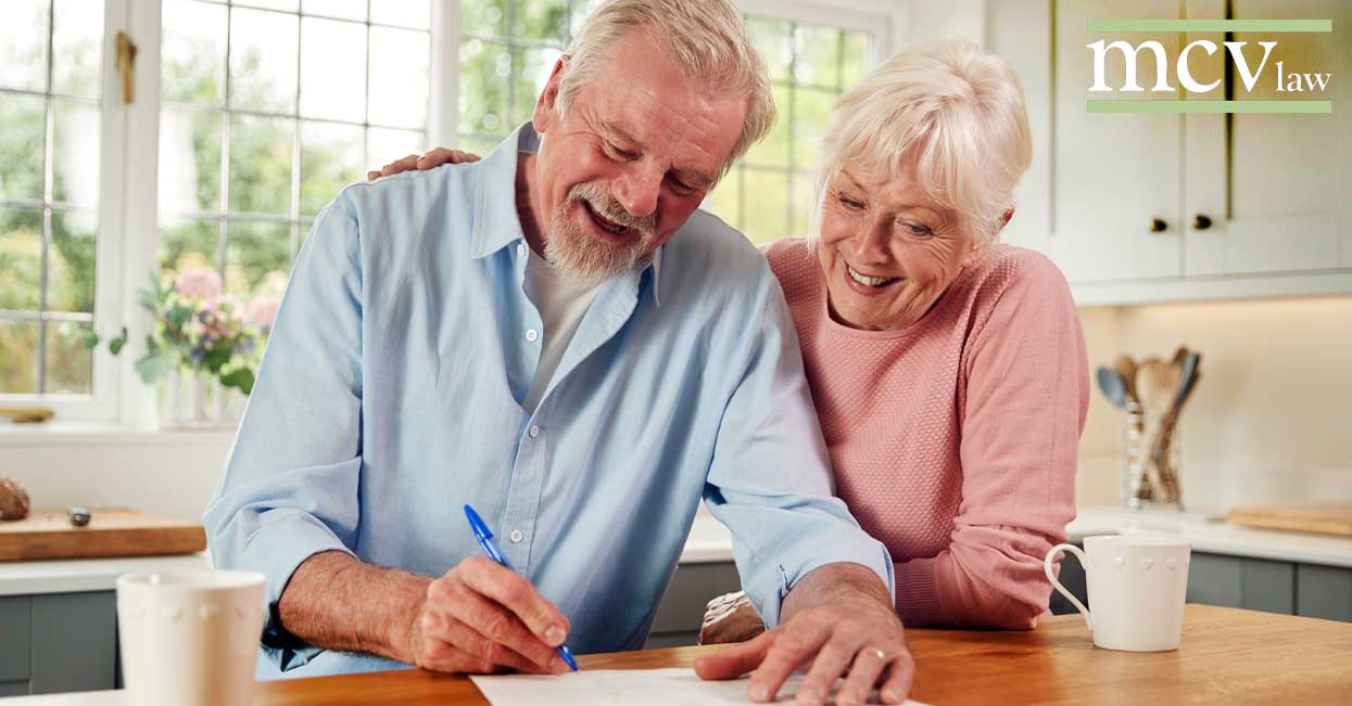 Older couple signing paperwork