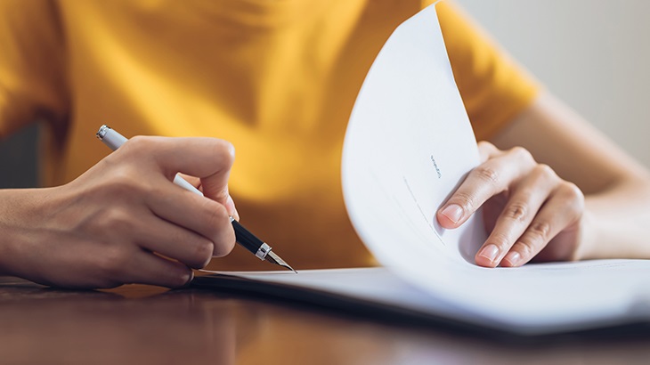 workers comp lawyers near oswego ny reviewing paperwork with client