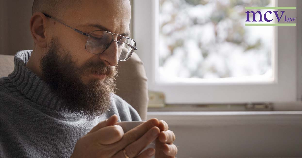 invisible disabilities and social security benefits in ny man holding coffee mug