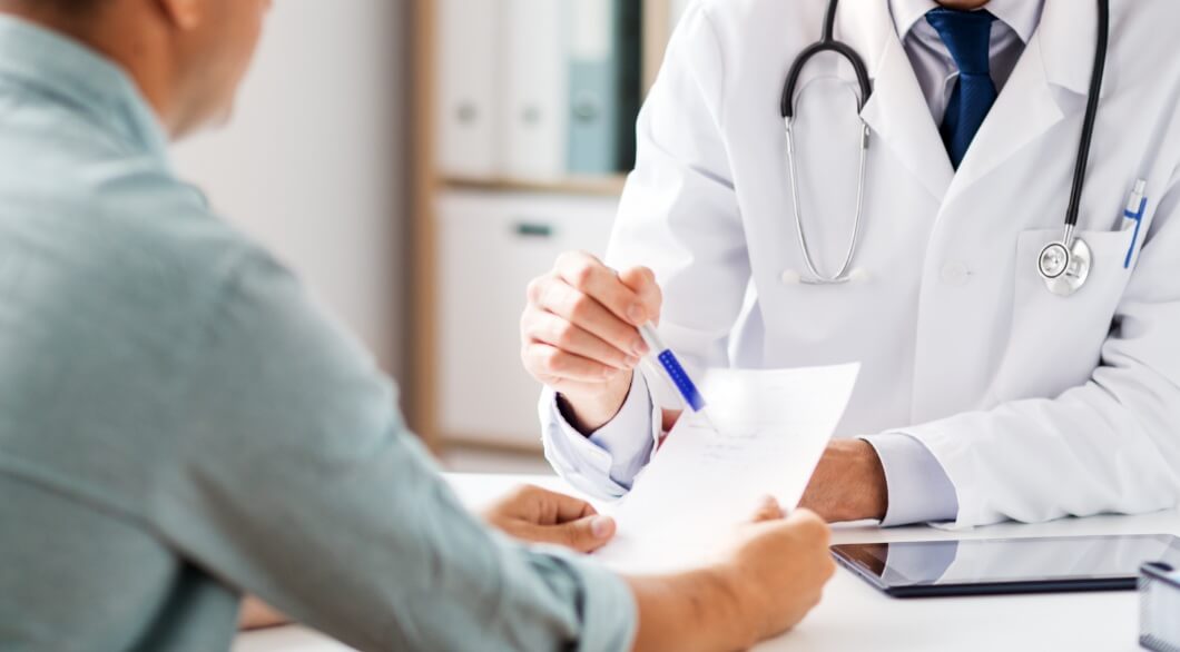 substantial gainful activity for social security disability benefits man looking at paperwork while talking with doctor