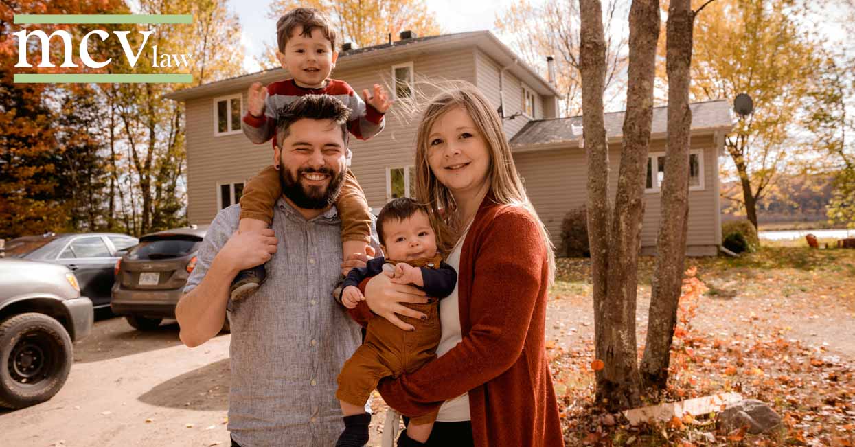 A family standing in front of their house