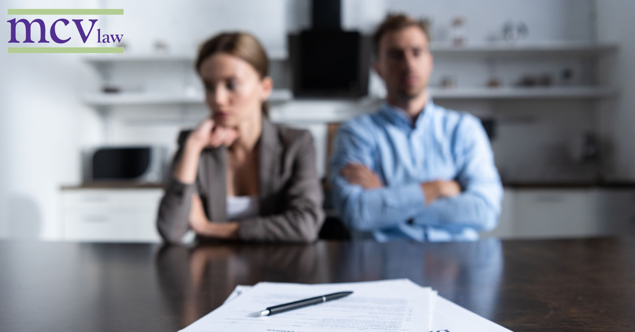 A man and a woman with divorce papers in front of them