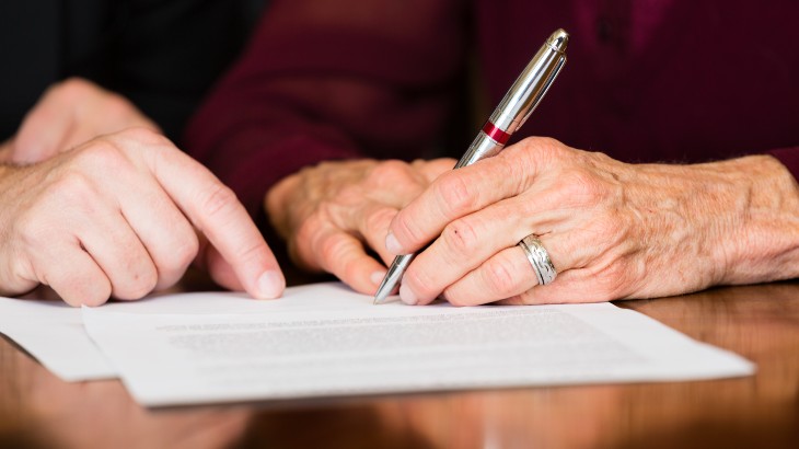 Estate Planning Attorneys near Syracuse NY image of hands signing documents