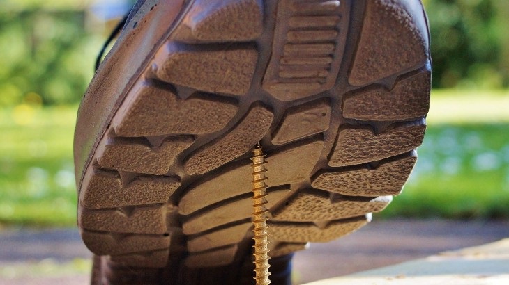 workers comp lawyers near oswego ny image of boot moments before stepping on nail