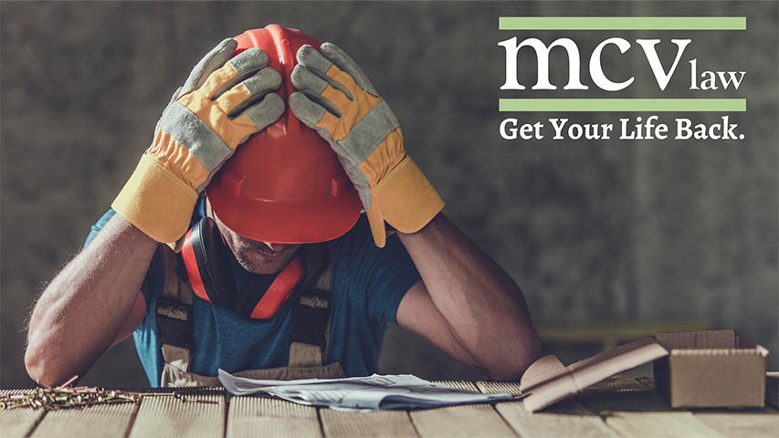 workers comp lawyers near oswego ny image of construction worker with hands on hard hat in frustration with mcv law logo get your life back
