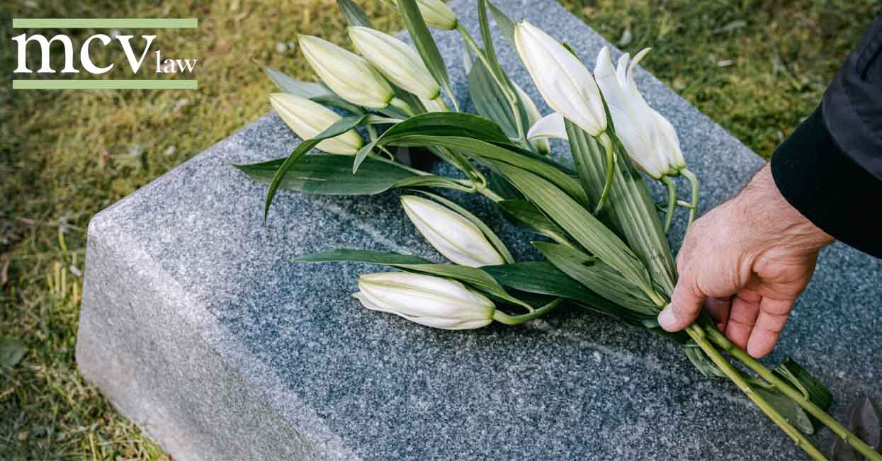 Flowers being laid on a gravestone