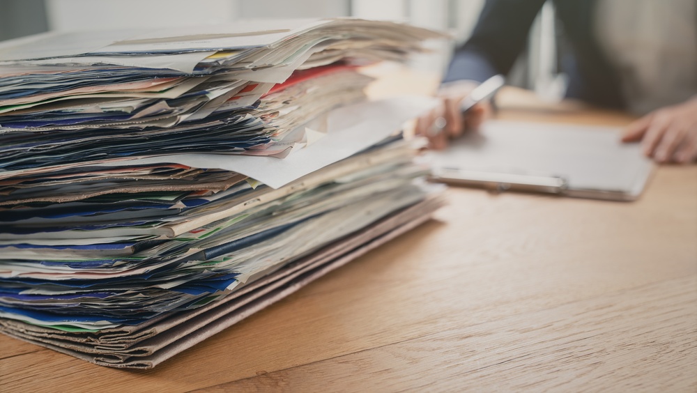Stylized image of legal representative going through physical case documents and evidence