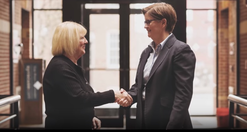 social security disability lawyers near syracuse ny image of kim slimbaugh and client shaking hands