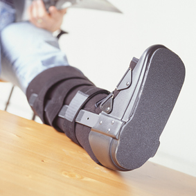 Injured worker in a soft boot preparing for light duty