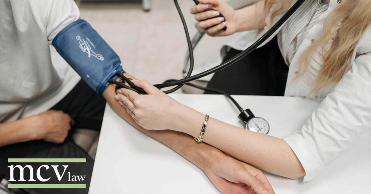 A doctor checking a patient's blood pressure