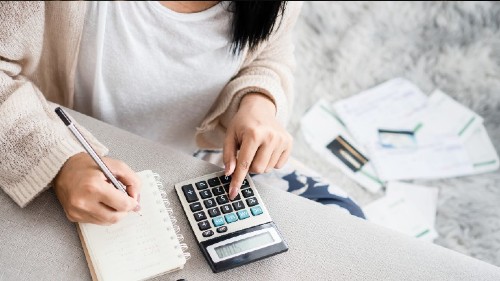 woman with calculator workers comp lawyers near syracuse ny