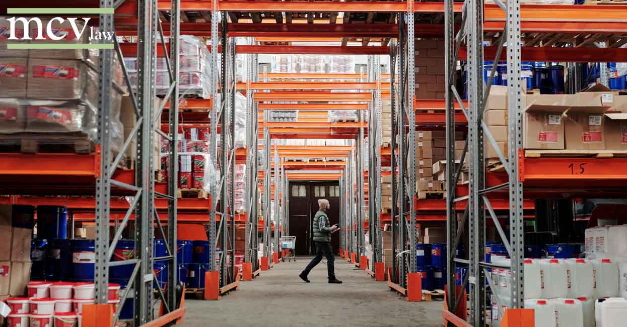 Warehouse worker walking through large warehouse